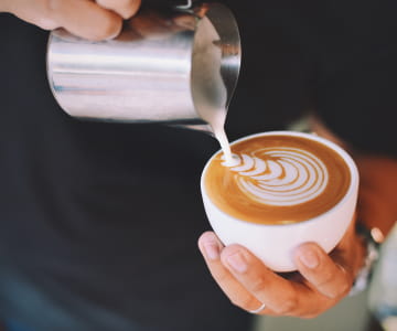 a hand holding a cup of coffee