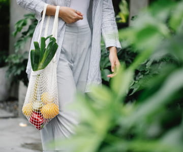 a person holding a bag with food